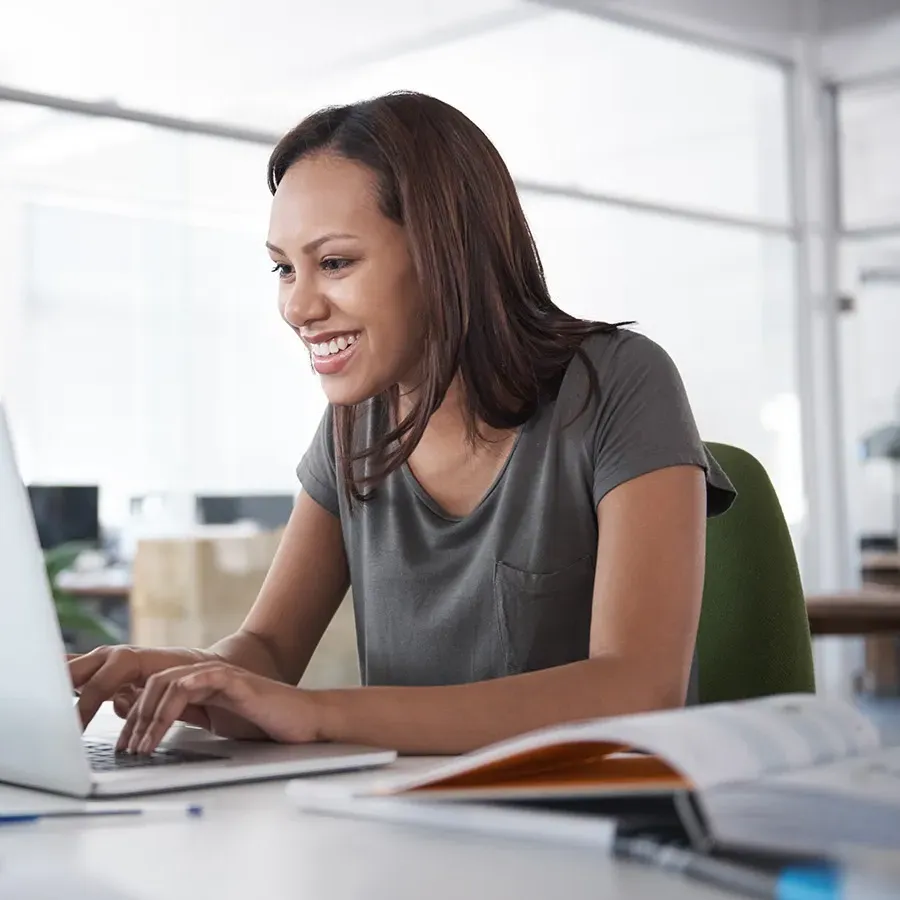 Online nursing student seated at laptop in home